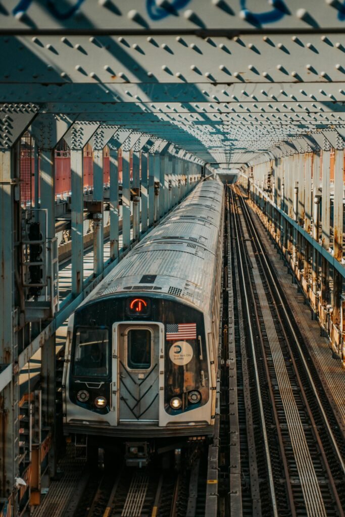 A New York subway train crossing a bridge, showcasing urban transportation in the city.