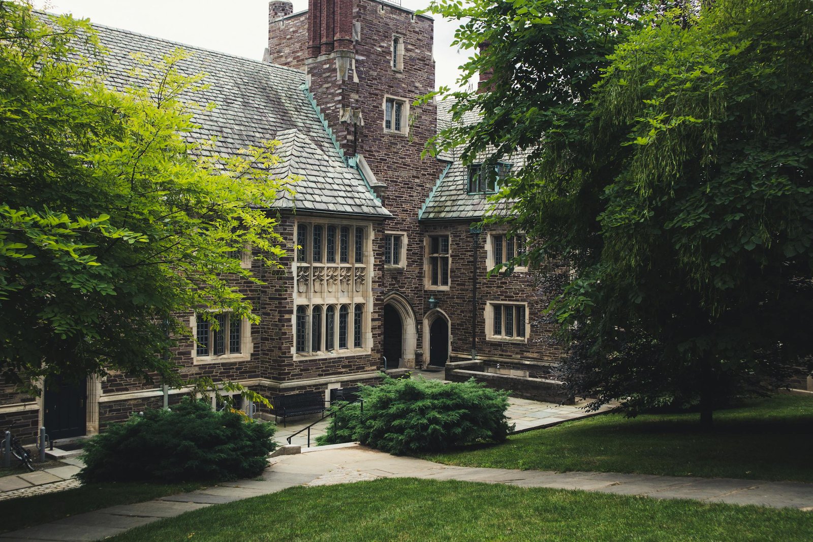 Elegant Gothic architecture of Princeton University surrounded by lush greenery on a summer day.