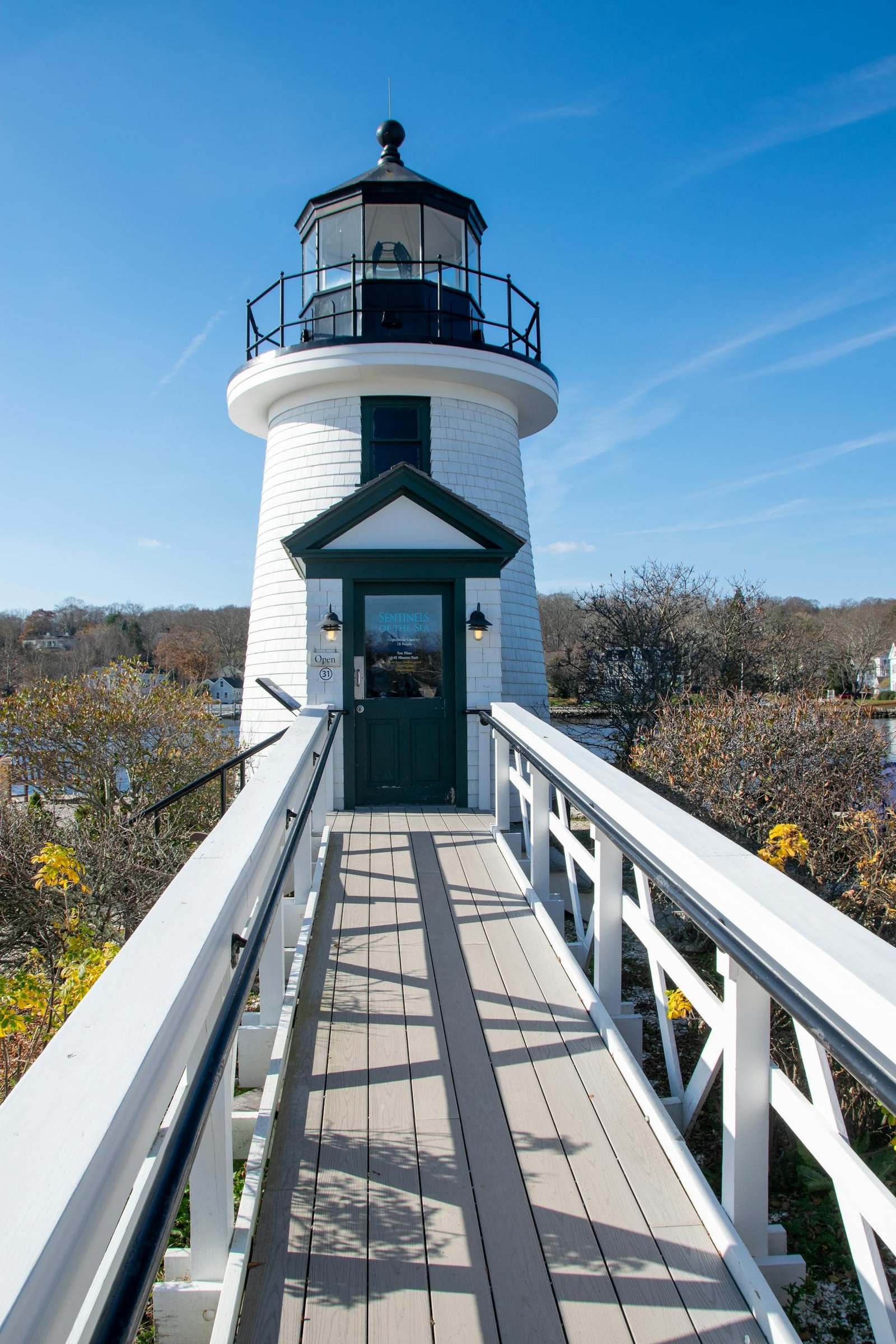 Lighthouse in Mystic Seaport, Connecticut on a sunny autumn day with clear skies.