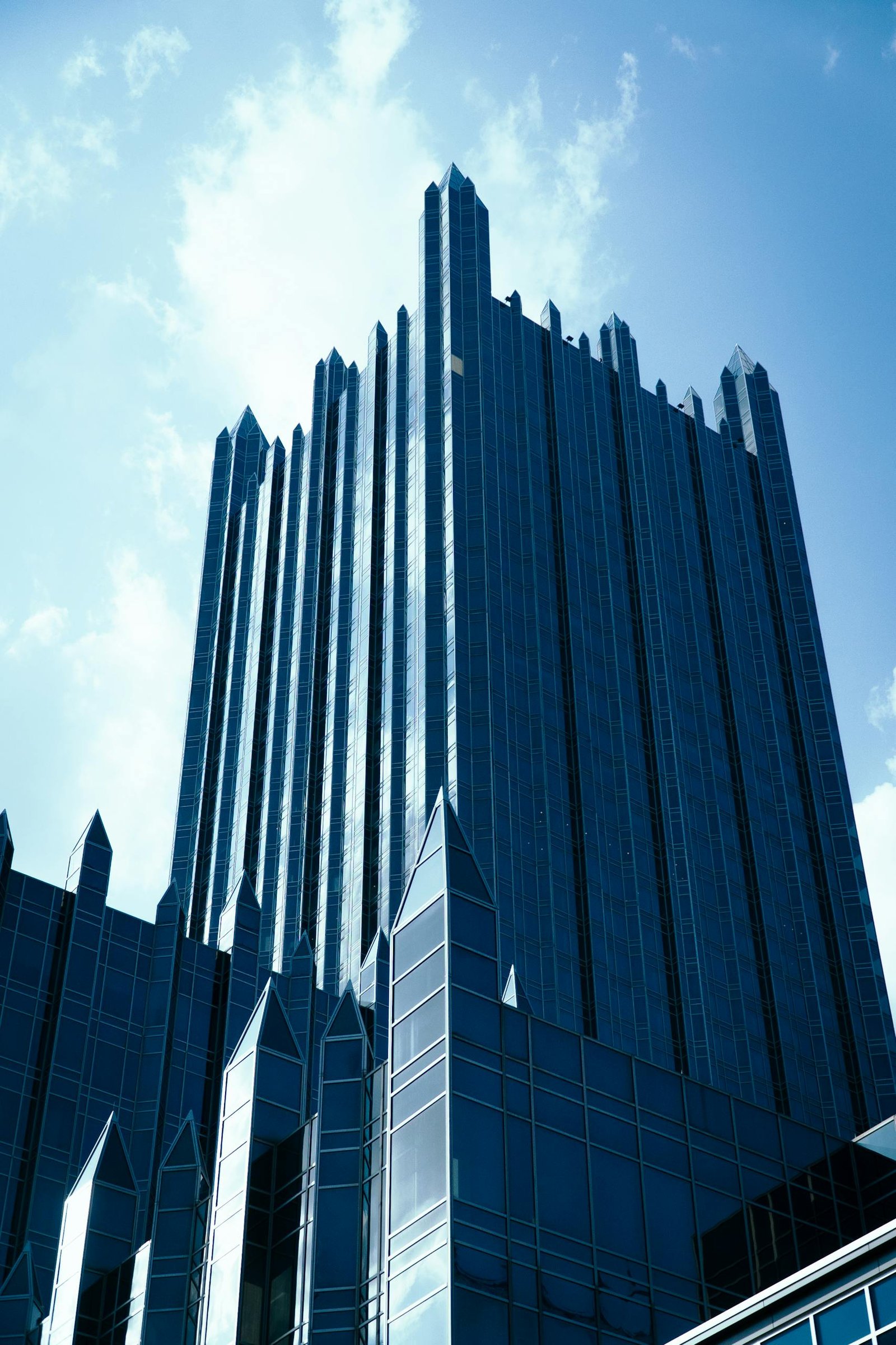 A striking view of modern architecture with towering skyscrapers under a clear sky.