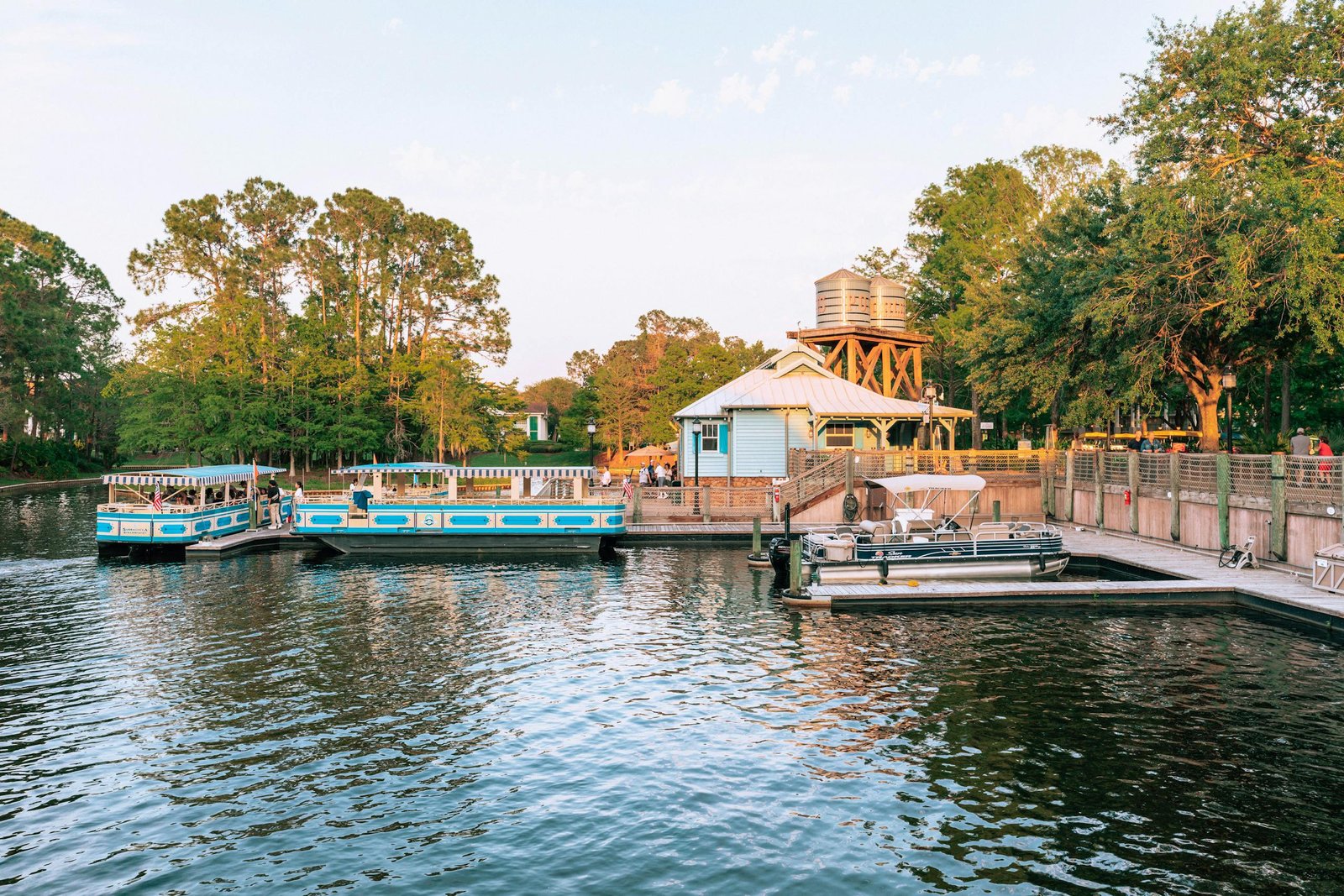Peaceful scene of boats docked at Port Orleans Riverside during sunset.