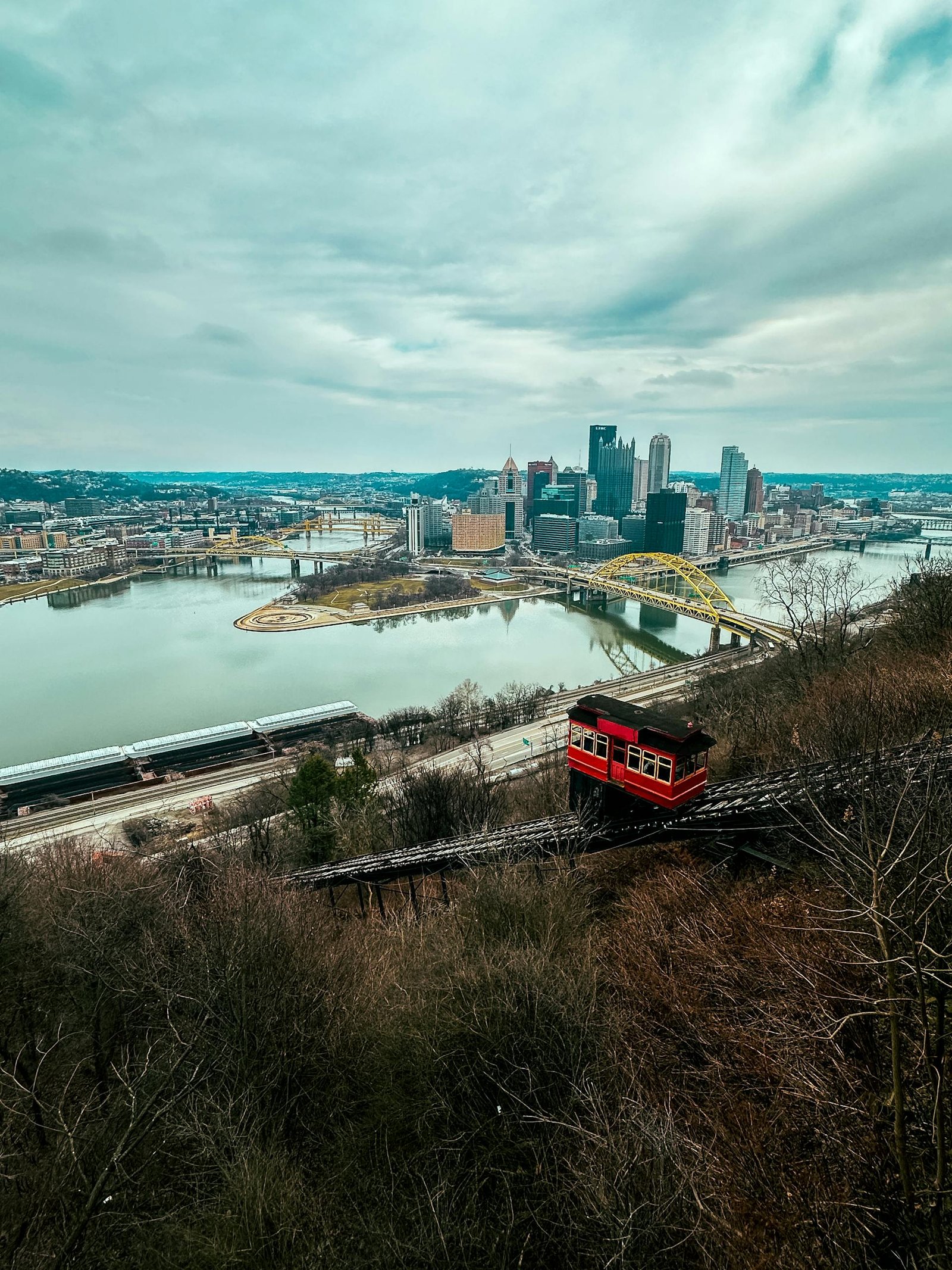 Scenic view of Pittsburgh skyline with Duquesne Incline and bridges, perfect for travel and cityscape enthusiasts.